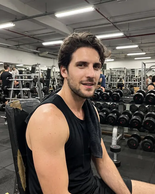 A fitness creator resting between sets at the gym