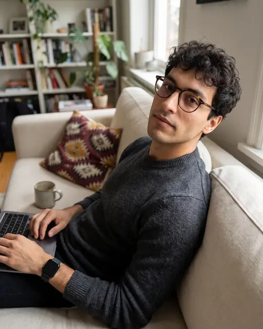 A tech creator on the sofa with his laptop